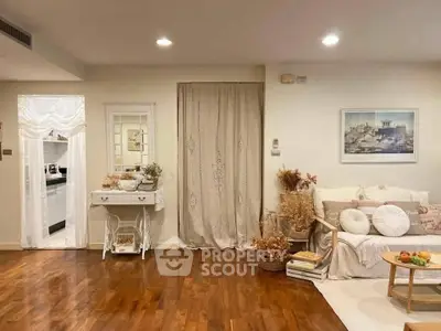 Charming living room with elegant decor and warm wooden flooring, perfect for cozy gatherings.