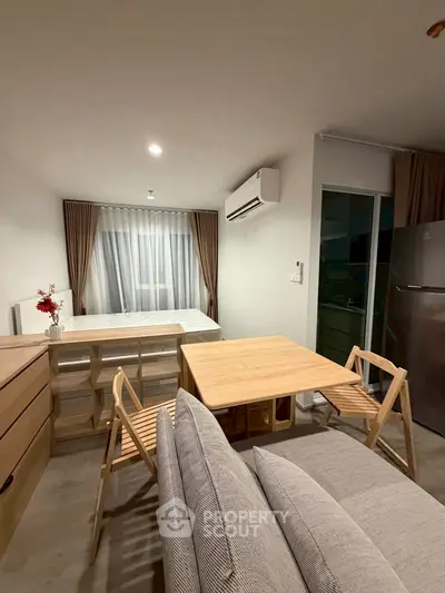 Modern studio apartment with cozy living area and stylish furniture