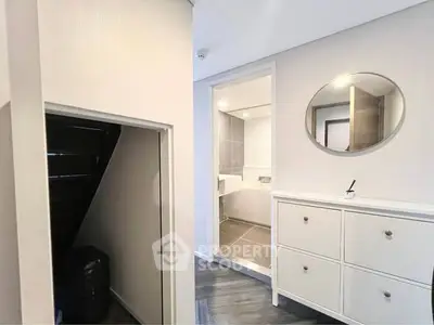 Modern hallway with sleek storage and bathroom entrance