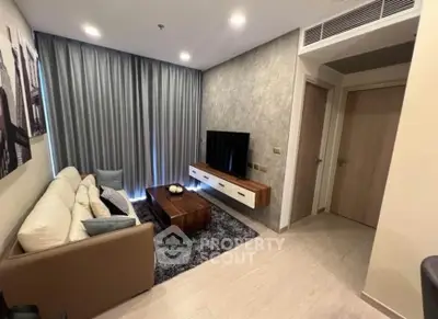Modern living room with cozy sofa, wall-mounted TV, and elegant decor