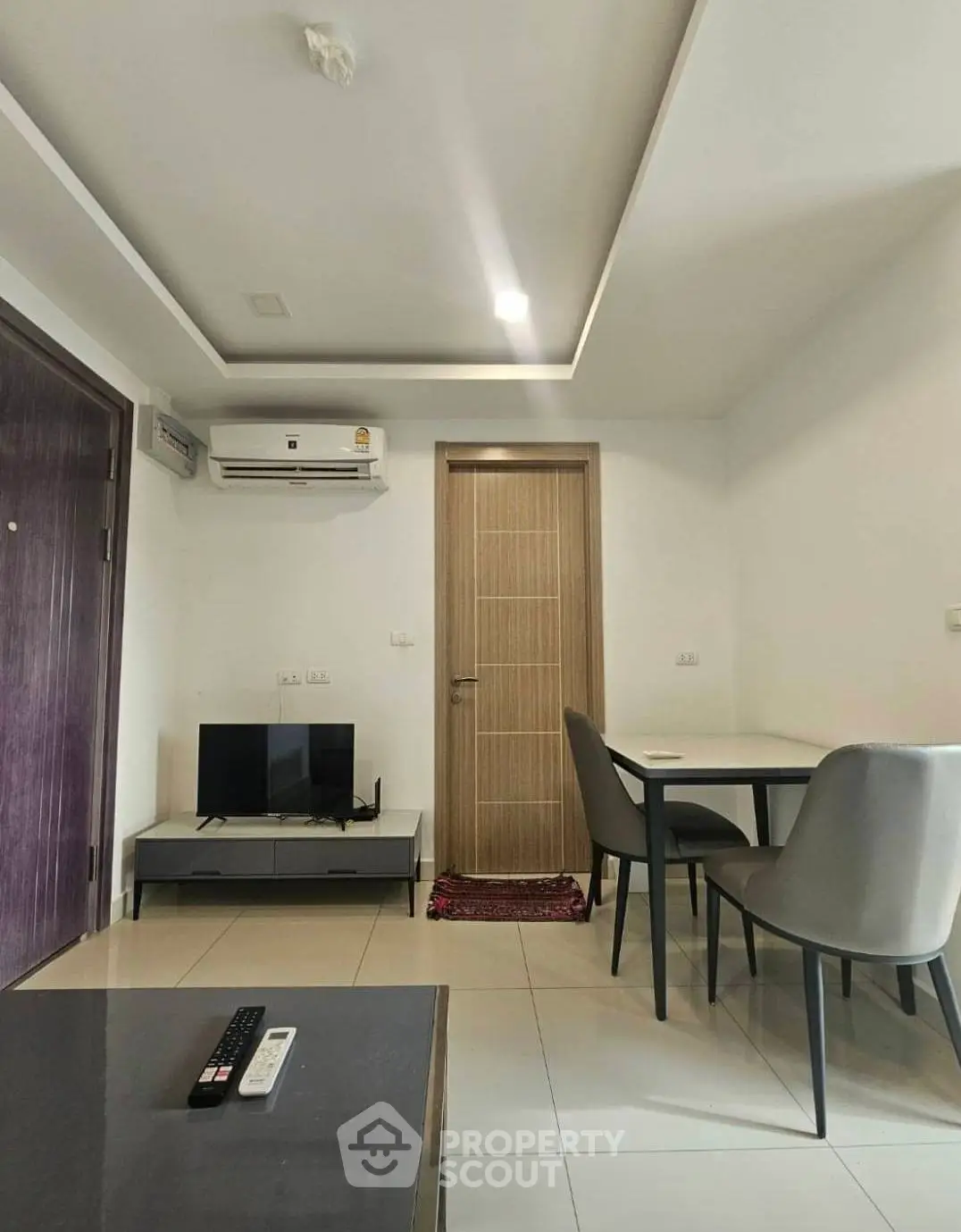 Modern living room with sleek furniture and air conditioning, perfect for comfortable living.