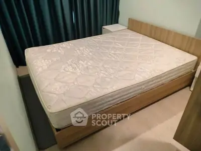 Cozy bedroom with a comfortable bed and modern wooden furniture, perfect for relaxation.