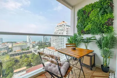 Stunning balcony with lush greenery and breathtaking city view, perfect for relaxation and enjoying the skyline.