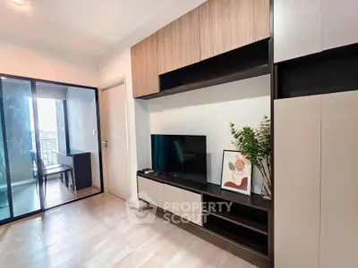 Modern living room with sleek TV unit and balcony view