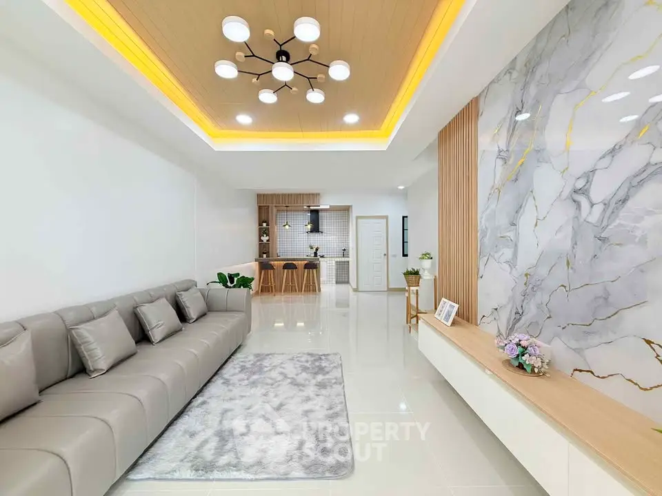 Modern living room with luxurious marble accent wall and elegant lighting