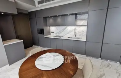 Modern kitchen with sleek gray cabinets and marble countertops