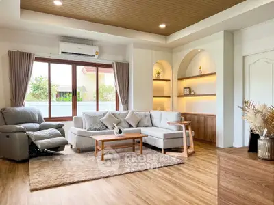 Spacious living room with modern decor and large windows for natural light.