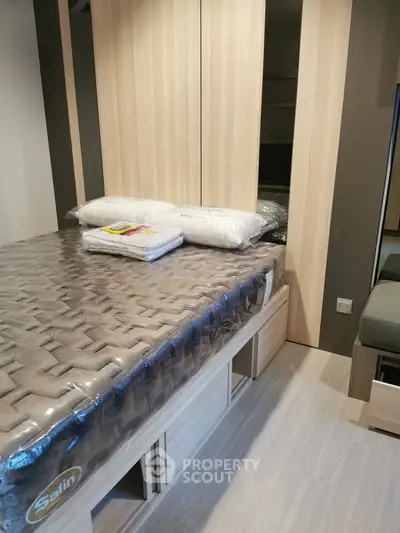 Modern bedroom with stylish wooden furniture and cozy bedding