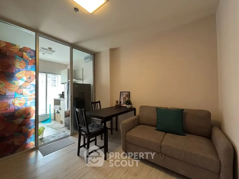 Cozy living room with dining area and modern decor in a stylish apartment.