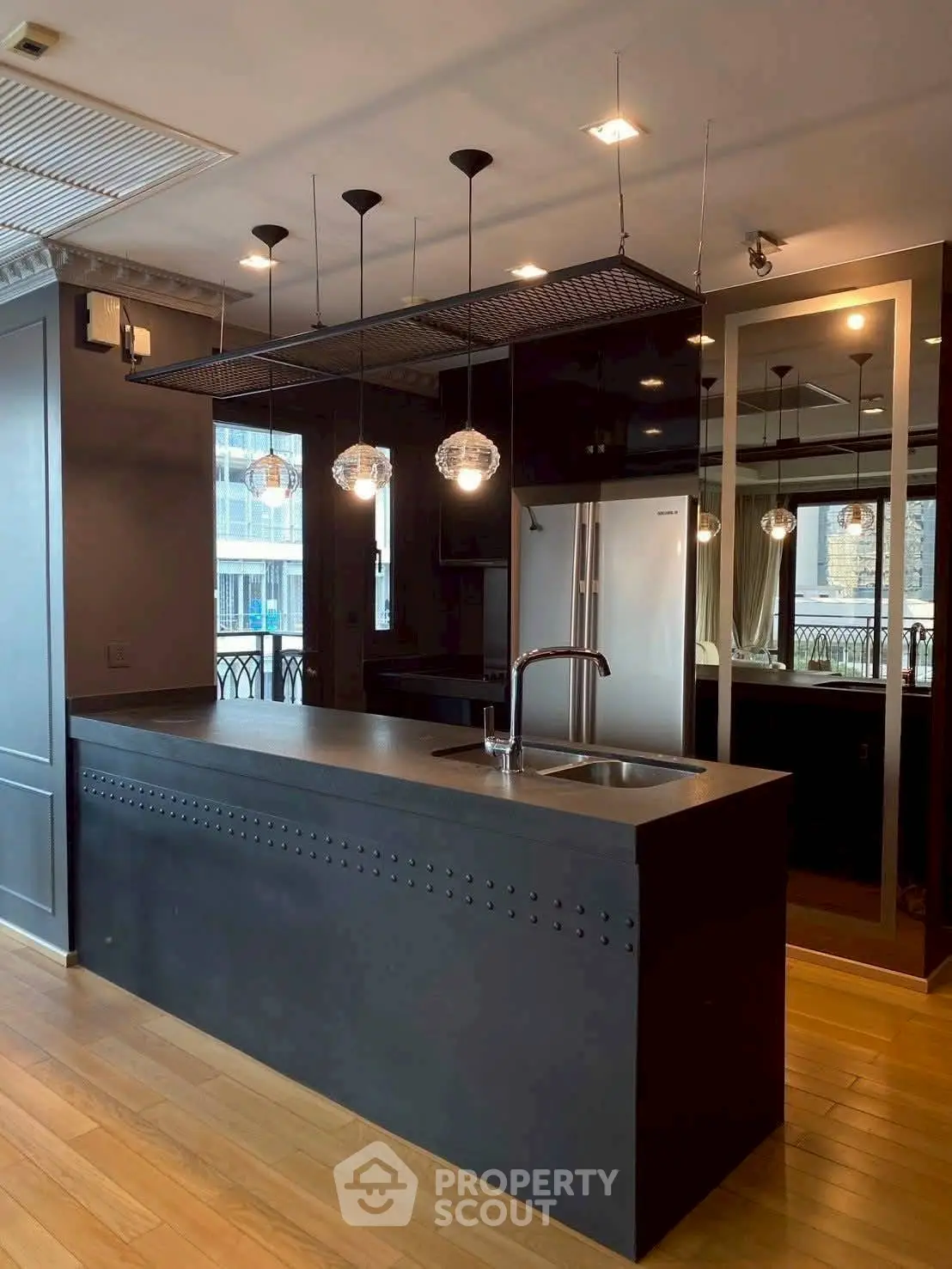 Modern kitchen with sleek black island and stylish pendant lighting