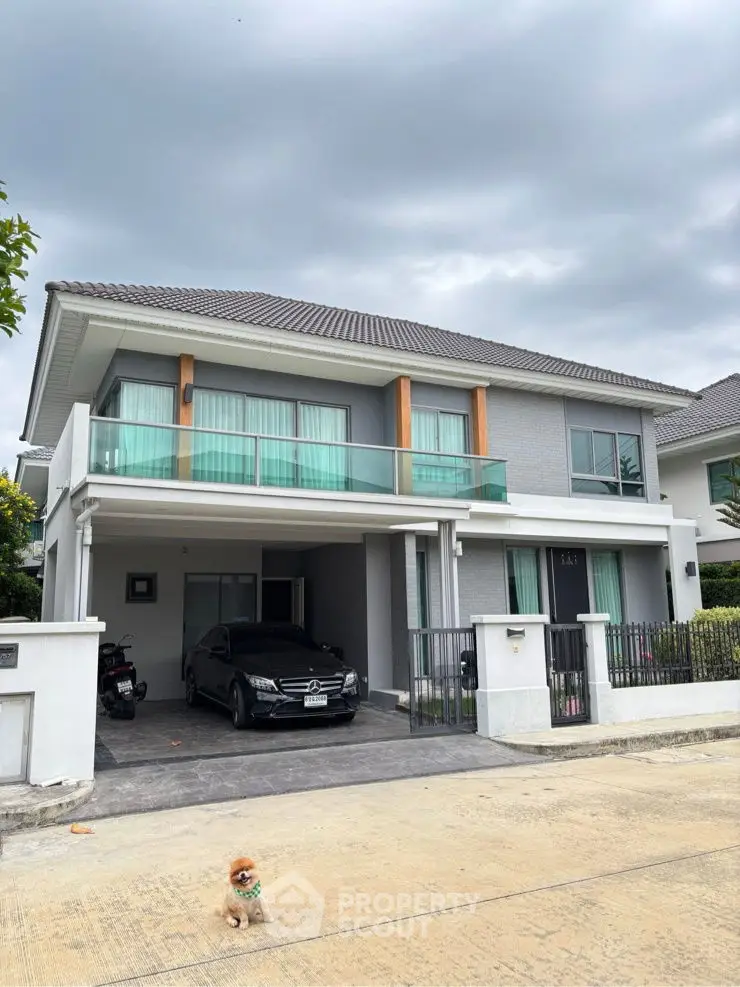 Modern two-story house with a sleek design and spacious driveway