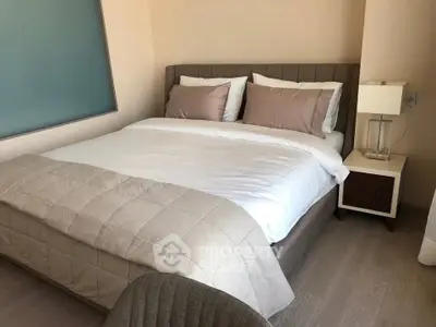 Cozy bedroom with modern decor and comfortable bedding in a stylish apartment.