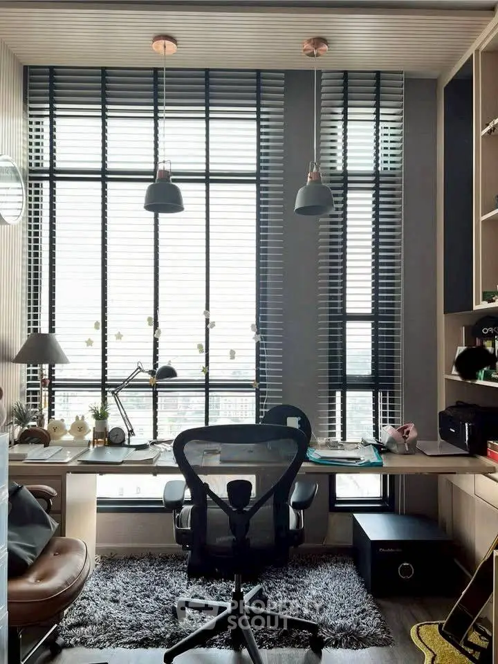 Modern study room with large windows and stylish furniture, perfect for productivity and comfort.