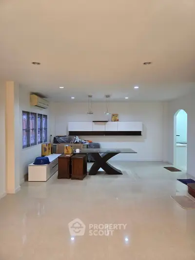 Spacious modern living room with sleek furniture and elegant lighting