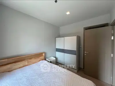 Modern bedroom with sleek wardrobe and minimalist design in a cozy apartment.
