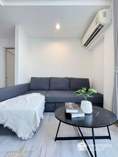 Modern living room with sleek furniture and air conditioning