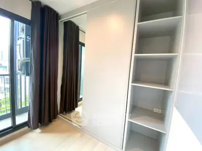 Modern bedroom with built-in wardrobe and large windows for natural light