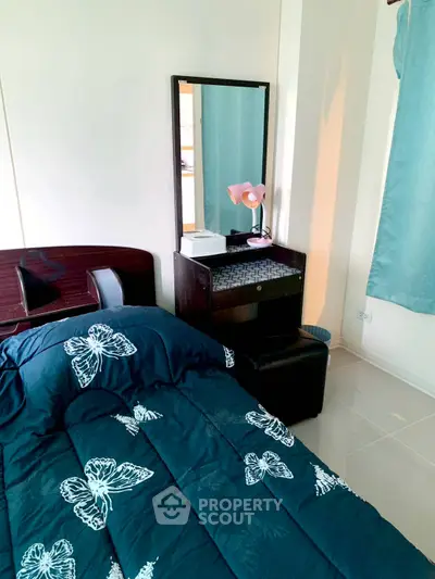 Cozy bedroom with elegant butterfly-themed bedding and stylish vanity mirror