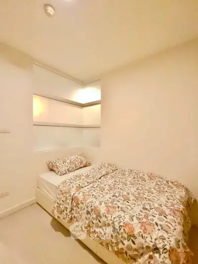 Cozy bedroom with floral bedding and modern design, perfect for a peaceful retreat.