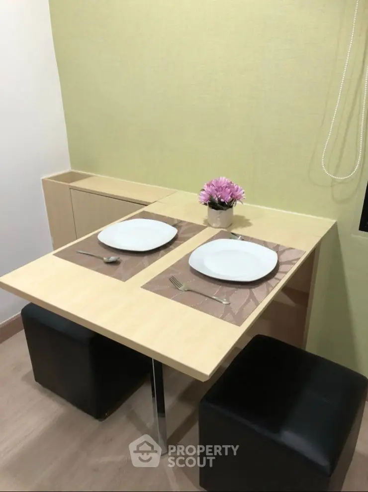 Cozy dining nook with modern table and seating, perfect for intimate meals.