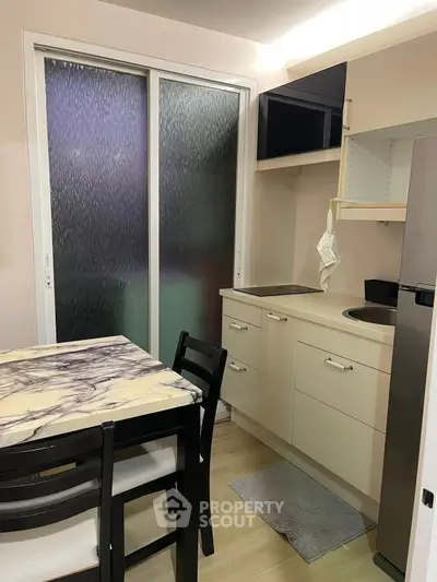 Cozy kitchen with modern appliances and dining area in compact space