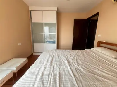 Spacious bedroom with modern wardrobe and cozy bed in a stylish apartment.