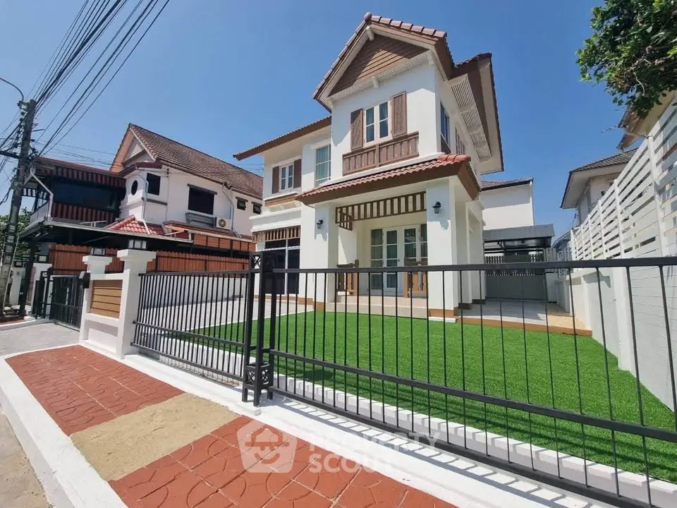 Charming two-story house with manicured lawn and modern design in a serene neighborhood.