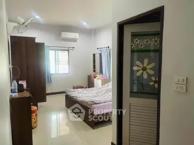 Cozy bedroom with modern furniture and natural light, perfect for relaxation.