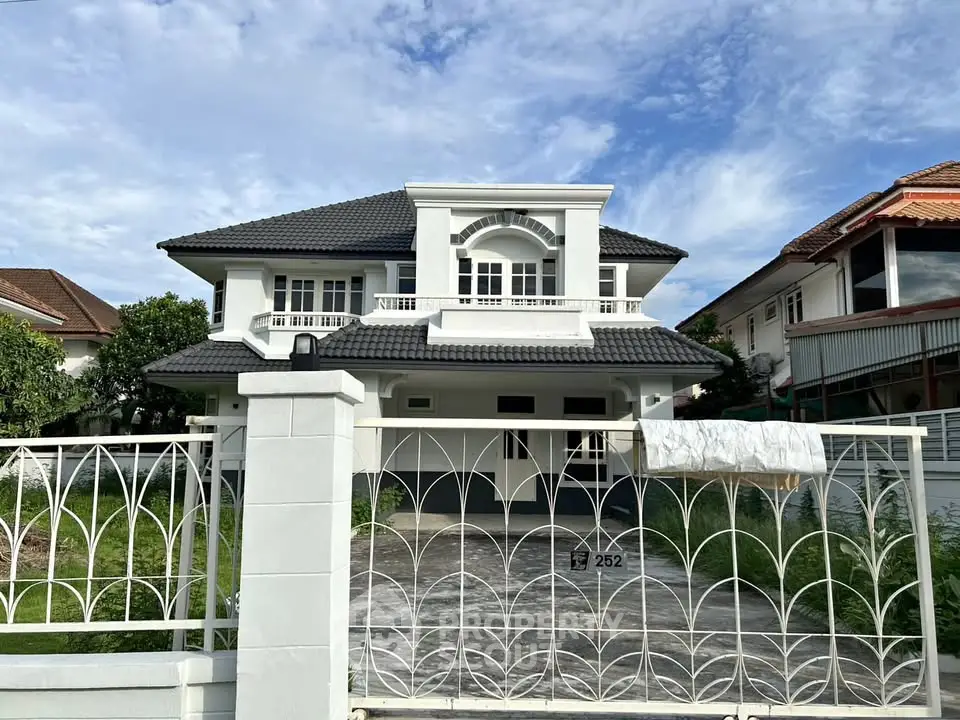 Charming two-story house with elegant facade and spacious driveway in a serene neighborhood.