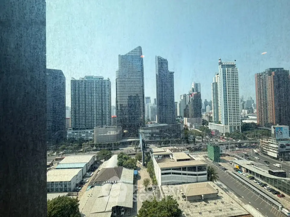Stunning cityscape view from a high-rise building window showcasing modern skyscrapers and urban landscape.