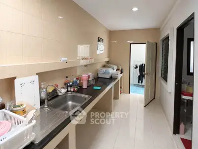 Spacious kitchen with sleek countertops and ample storage in modern home