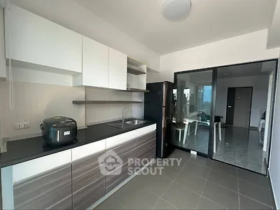 Modern kitchen with sleek cabinets and appliances in a stylish apartment