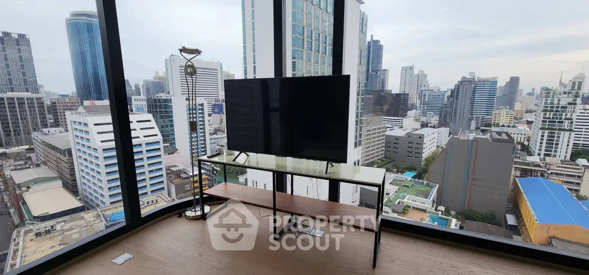 Stunning city view from modern high-rise apartment with floor-to-ceiling windows and sleek interior design.