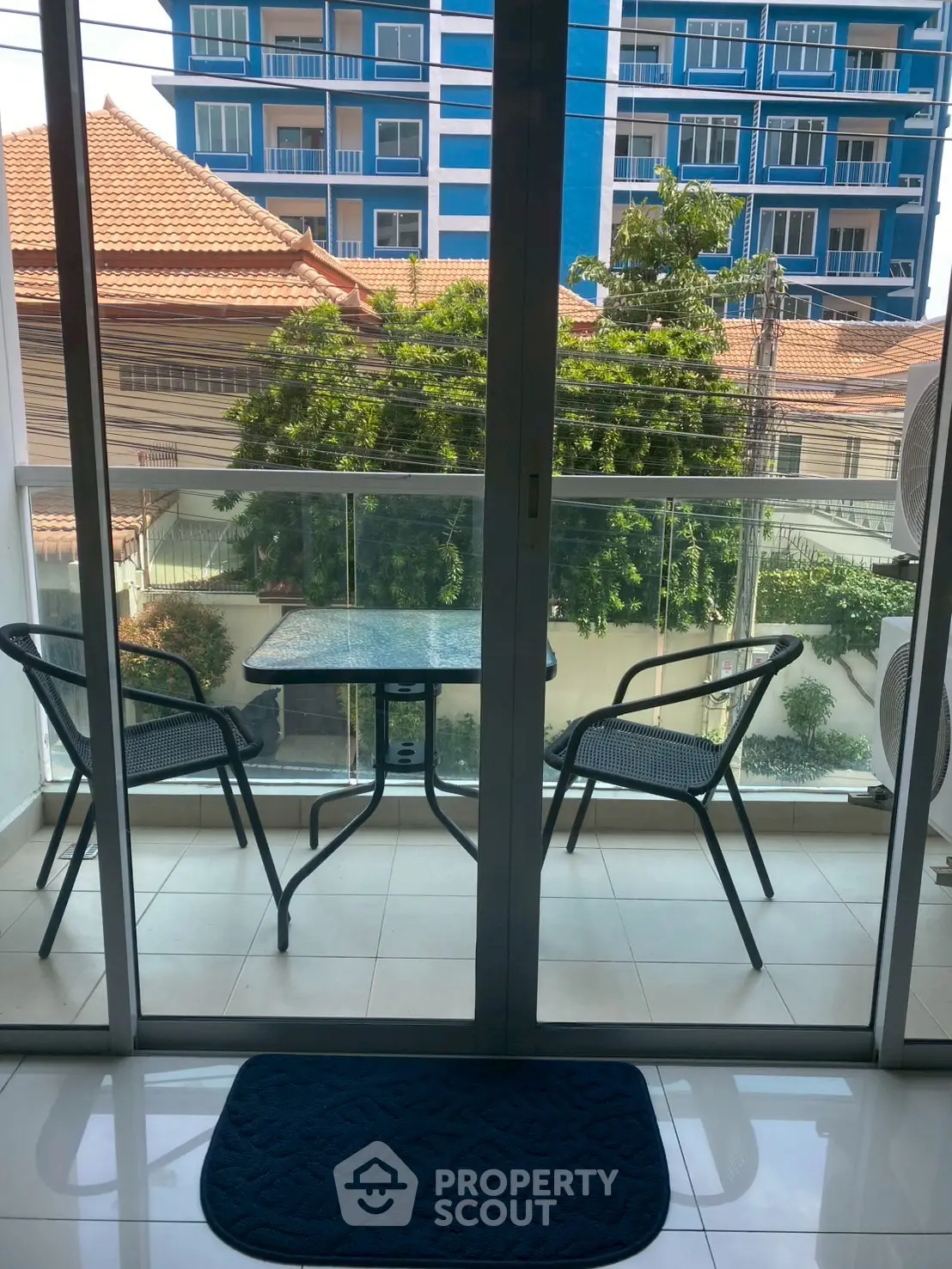 Charming balcony with seating and lush view, perfect for relaxation.