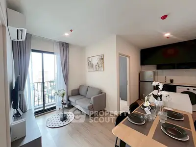 Modern living room with dining area and balcony view in a stylish apartment.
