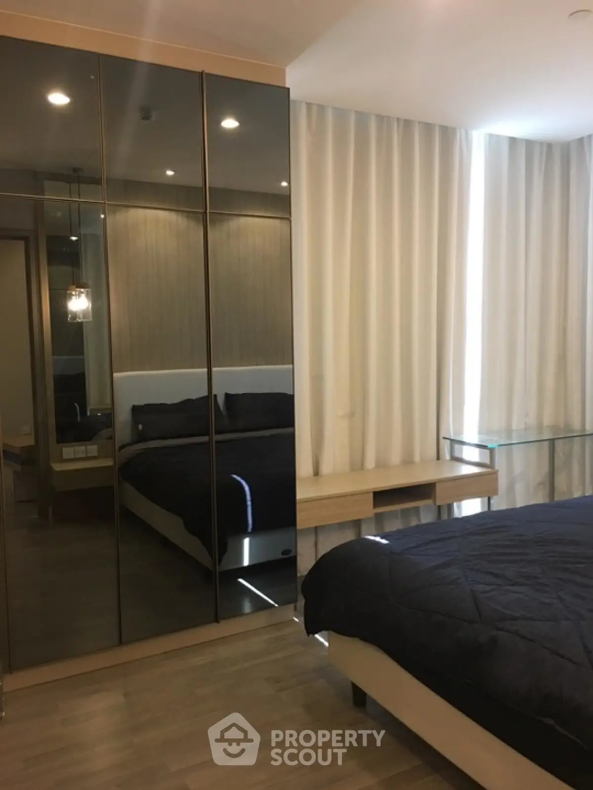 Modern bedroom with mirrored wardrobe and elegant decor