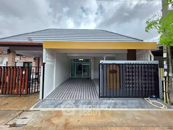 Modern single-story home with sleek design and spacious driveway