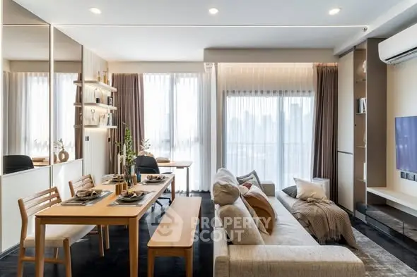 Modern living room with dining area, stylish decor, and large windows offering city views.