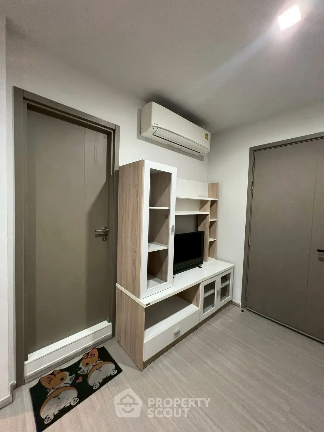 Modern living room with sleek TV unit and air conditioning