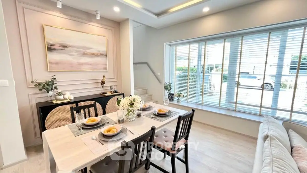 Elegant dining area with modern decor and large window view
