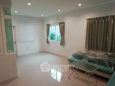 Spacious unfurnished room with large windows and tiled flooring, ideal for customization.