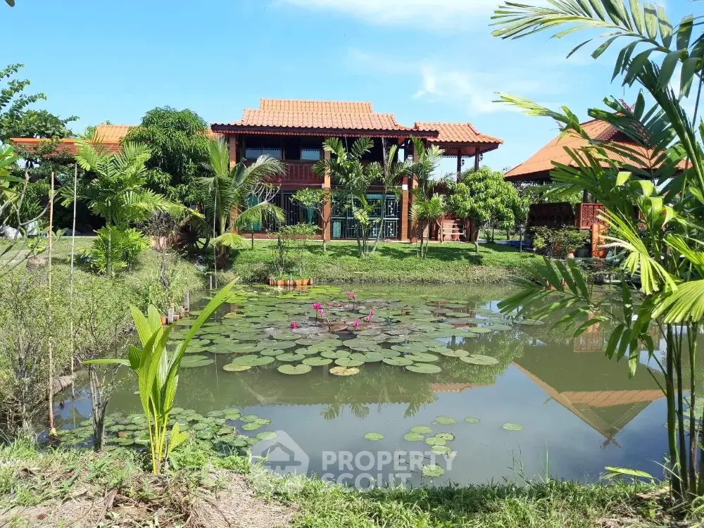 Charming tropical villa with lush garden and serene pond view