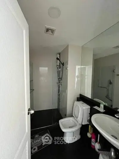 Modern bathroom with sleek fixtures and spacious shower area.