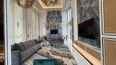 Luxurious living room with high ceilings, elegant chandeliers, and modern decor in a sophisticated setting.