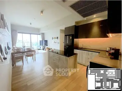 Modern open-layout kitchen and living room with sleek design and balcony view.