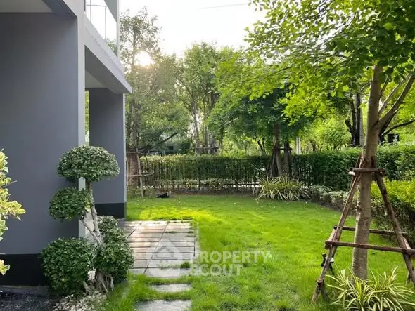 Charming garden view with lush greenery and modern exterior design, perfect for relaxation and outdoor activities.