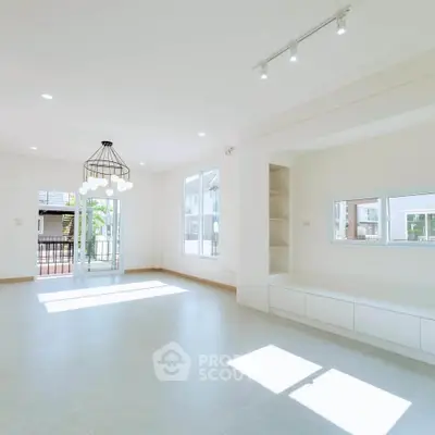 Spacious and bright living room with modern lighting and large windows