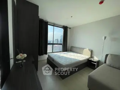 Spacious bedroom with city view, modern furnishings, and ample natural light.