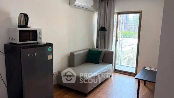 Cozy living room with modern appliances and balcony view