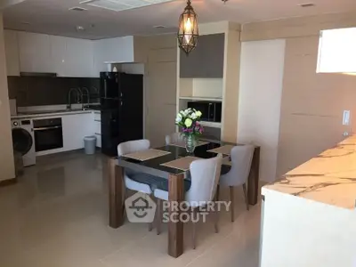 Modern kitchen and dining area with sleek appliances and elegant decor